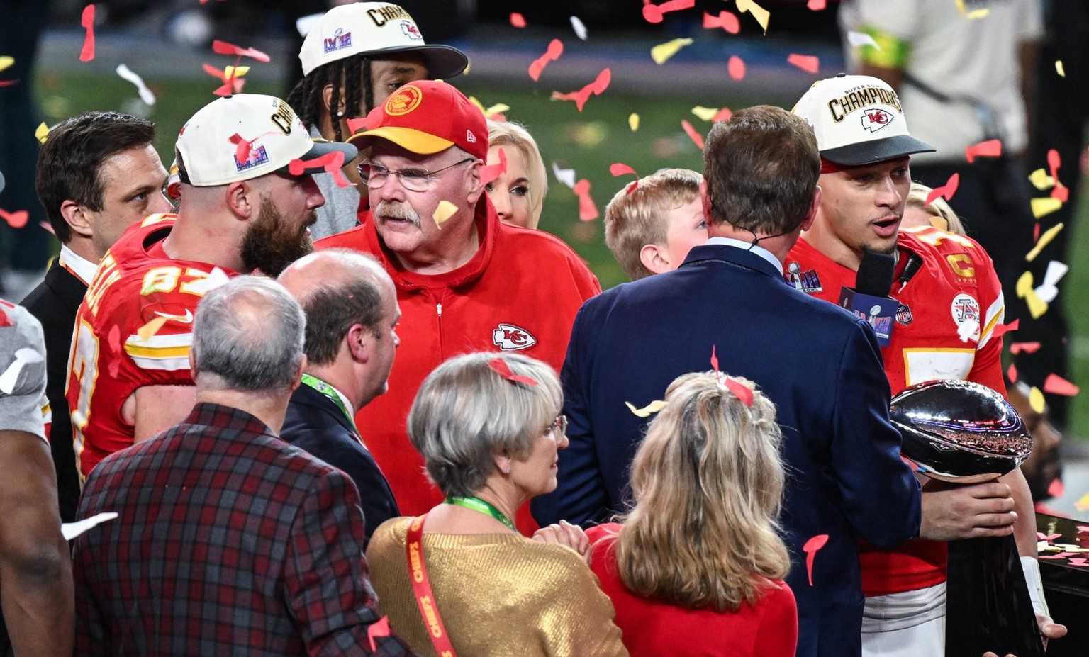 NFL: Super Bowl LVIII - Post-Game celebrations Kansas City Chiefs tight end 87 Travis Kelce, Head Coach Andy Reid and Quarterback Patrick Mahomes celebrate on the podium with the Vince Lombardo Trophy ...