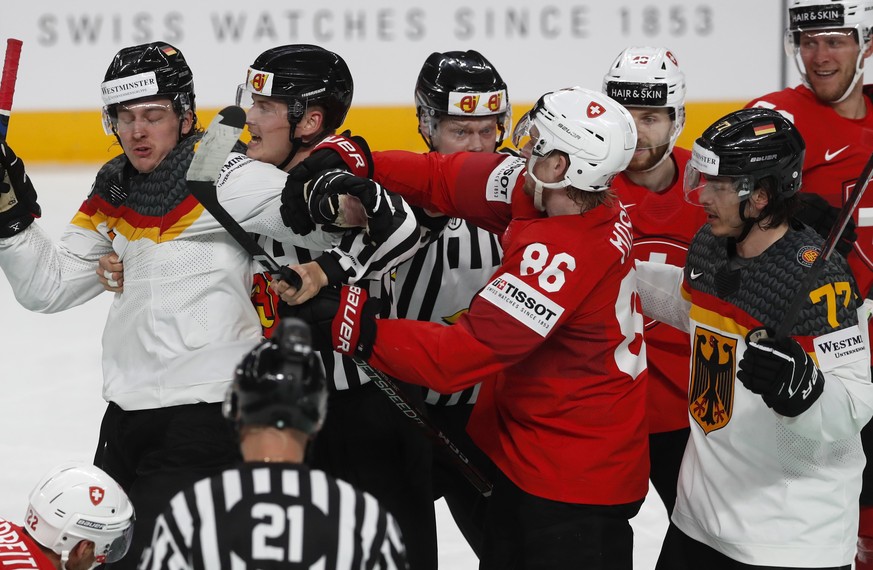 epa10653017 A referee intervenes to stop a clash during the quarter final match between Switzerland and Germany at the IIHF Ice Hockey World Championship 2023 in Riga, Latvia, 25 May 2023. EPA/TOMS KA ...