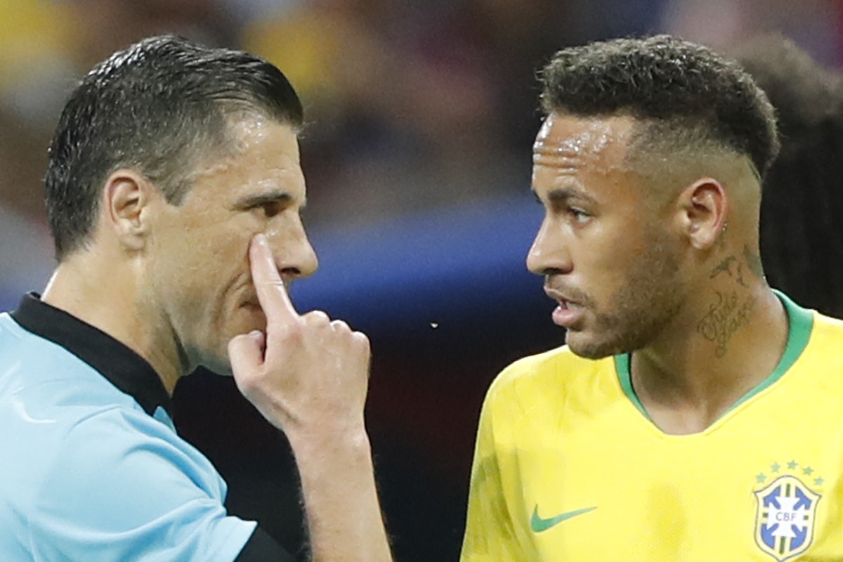 Referee Milorad Mazic from Serbia, left, gestures as he speaking to Brazil's Neymar during the quarterfinal match between Brazil and Belgium at the 2018 soccer World Cup in the Kazan Arena, in Ka ...