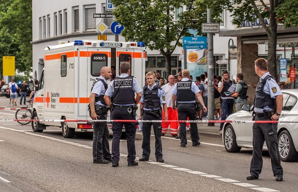 epa05439388 Police officers at a crime scene in Reutlingen, Germany, 24 July 2016. Nearby, a man reportedly killed a woman with a machete and injured two other people. The man was arrested. The motive ...