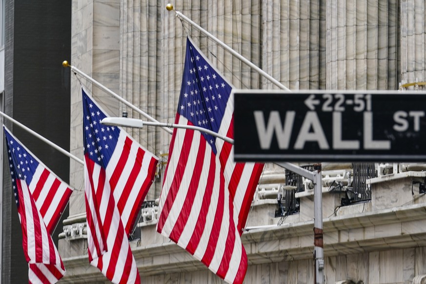 FILE - American flags hang outside of the New York Stock Exchange, in this Tuesday, Feb. 16, 2021, file photo. Technology companies are off to another good start on Wall Street, a day after powering a ...