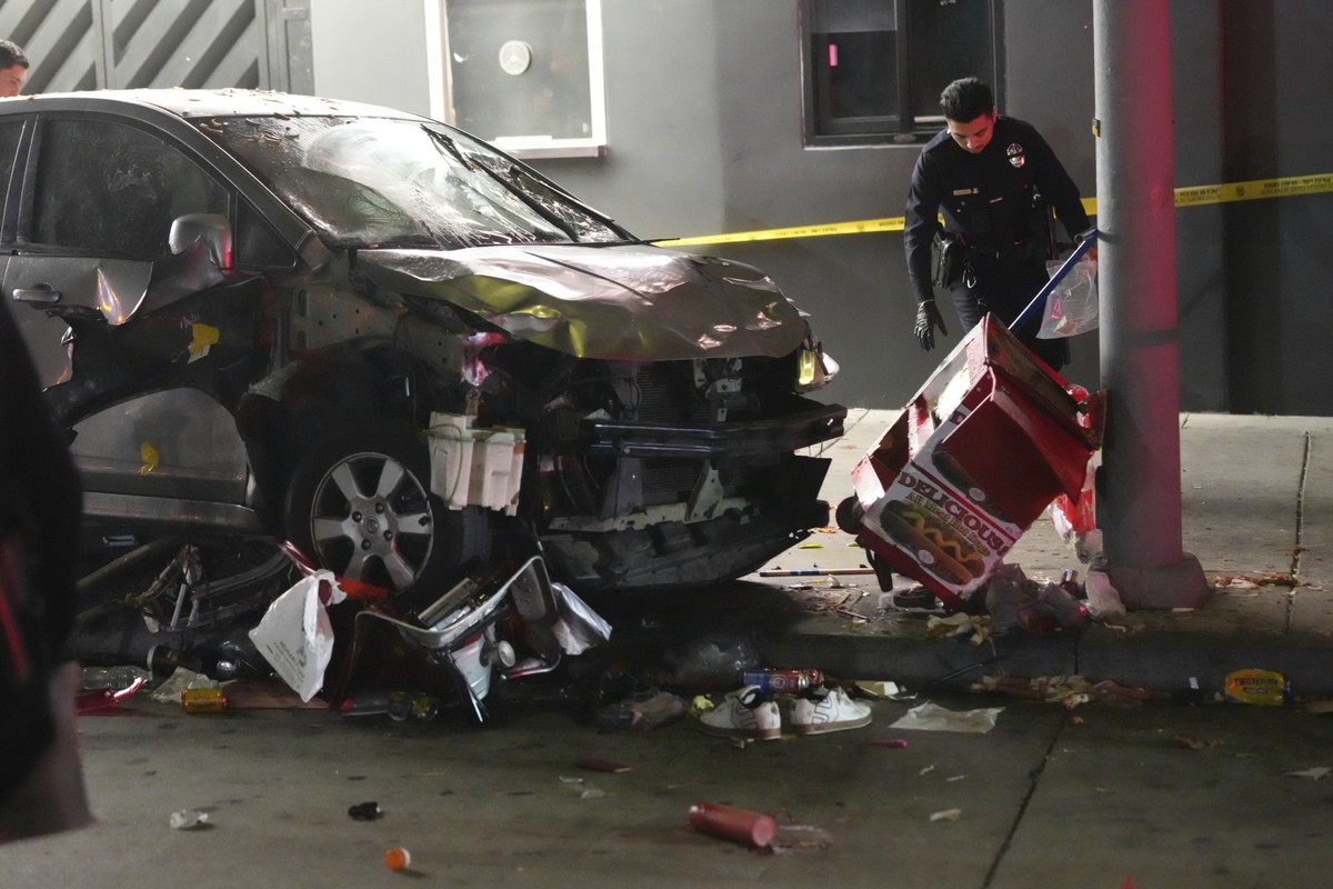 A vehicle sits on the sidewalk after ramming into a crowd of people waiting to enter a nightclub along a busy boulevard in Los Angeles early Saturday, July 19, 2025 injuring several people. (AP Photo/ ...