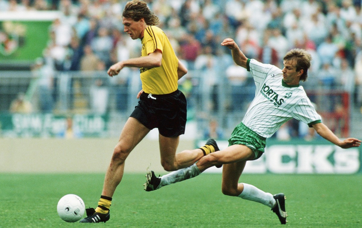 BREMEN, GERMANY - SEPTEMBER 29: Michael Schulz of Borussia Dortmund challenges Manfred Bockenfeld of Werder Bremen during the 1.bundesliga game between Werder Bremen and Borussia Dortmund at the Weser ...