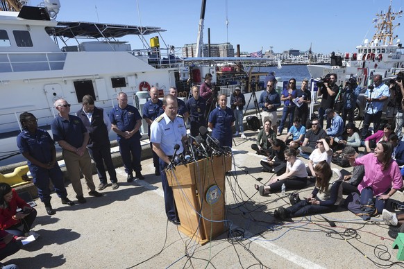 U.S. Coast Guard Rear Adm. John Mauger, commander of the First Coast Guard District, center at microphone, talks to the media Thursday, June 22, 2023, at Coast Guard Base Boston, in Boston. The U.S. C ...