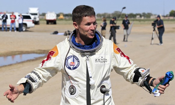 FILE - Felix Baumgartner of Austria gestures prior to speaking with the media after successfully jumping from a space capsule lifted by a helium balloon in Roswell, N.M., Oct. 14, 2012. (AP Photo/Ross ...