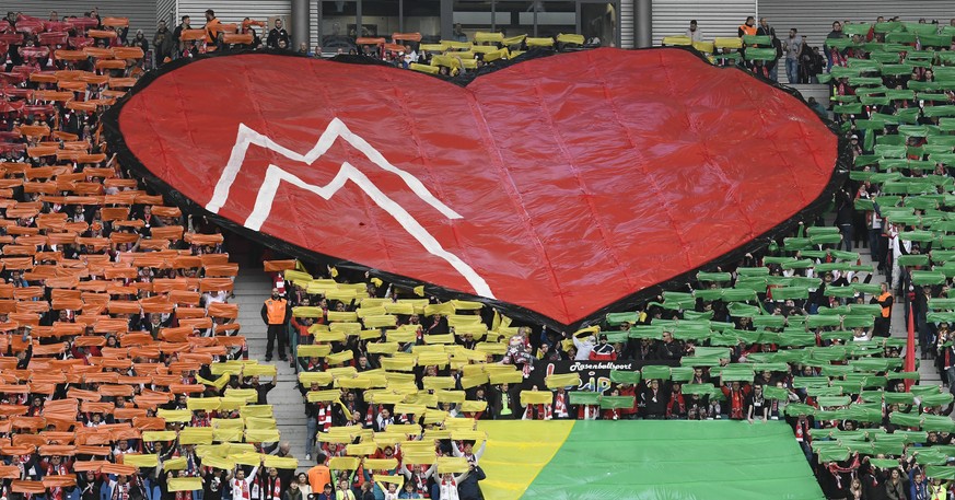 Leipzig fans celebrate with a heart during the German first division Bundesliga soccer match between RB Leipzig and Bayer 04 Leverkusen in Leipzig, Germany, Saturday, April 8, 2017. (AP Photo/Jens Mey ...