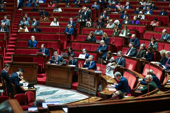 epa11023299 French Interior Minister Gerald Darmanin (C) attends a debate on the new immigration bill at the National Assembly in Paris, France, 11 December 2023. The deputies of the National Assembly ...