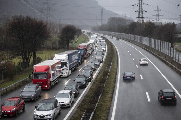 epa11022924 Vehicles in a traffic jam as the police has installed checkpoints along roads following a shooting, in Sion, Switzerland, 11 December 2023. A manhunt was underway after two people were kil ...