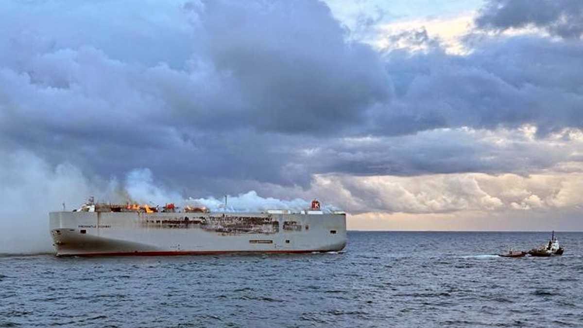 Smoke and flames are seen on a freight ship in the North Sea, about 27 kilometers (17 miles) north of the Dutch island of Ameland, Wednesday, July 26, 2023. A fire on the freight ship Fremantle Highwa ...
