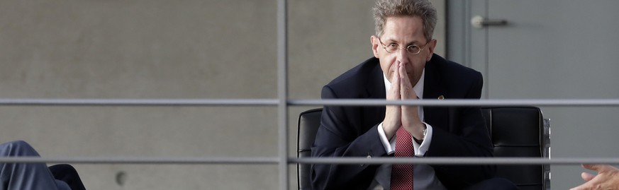 FILE- In this Wednesday, Sept. 12, 2018 photo Hans-Georg Maassen, center, head of the German Federal Office for the Protection of the Constitution, waits for the beginning of a hearing at the home aff ...