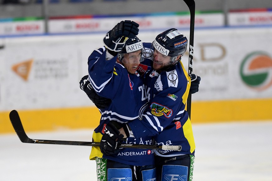 Ambri&#039;s player Diego Kostner, left, celebrates the 1-0 with Ambri&#039;s player Adam Hall, right, during the first league qualification ice hockey game of the Swiss Championship 2016/17 between N ...