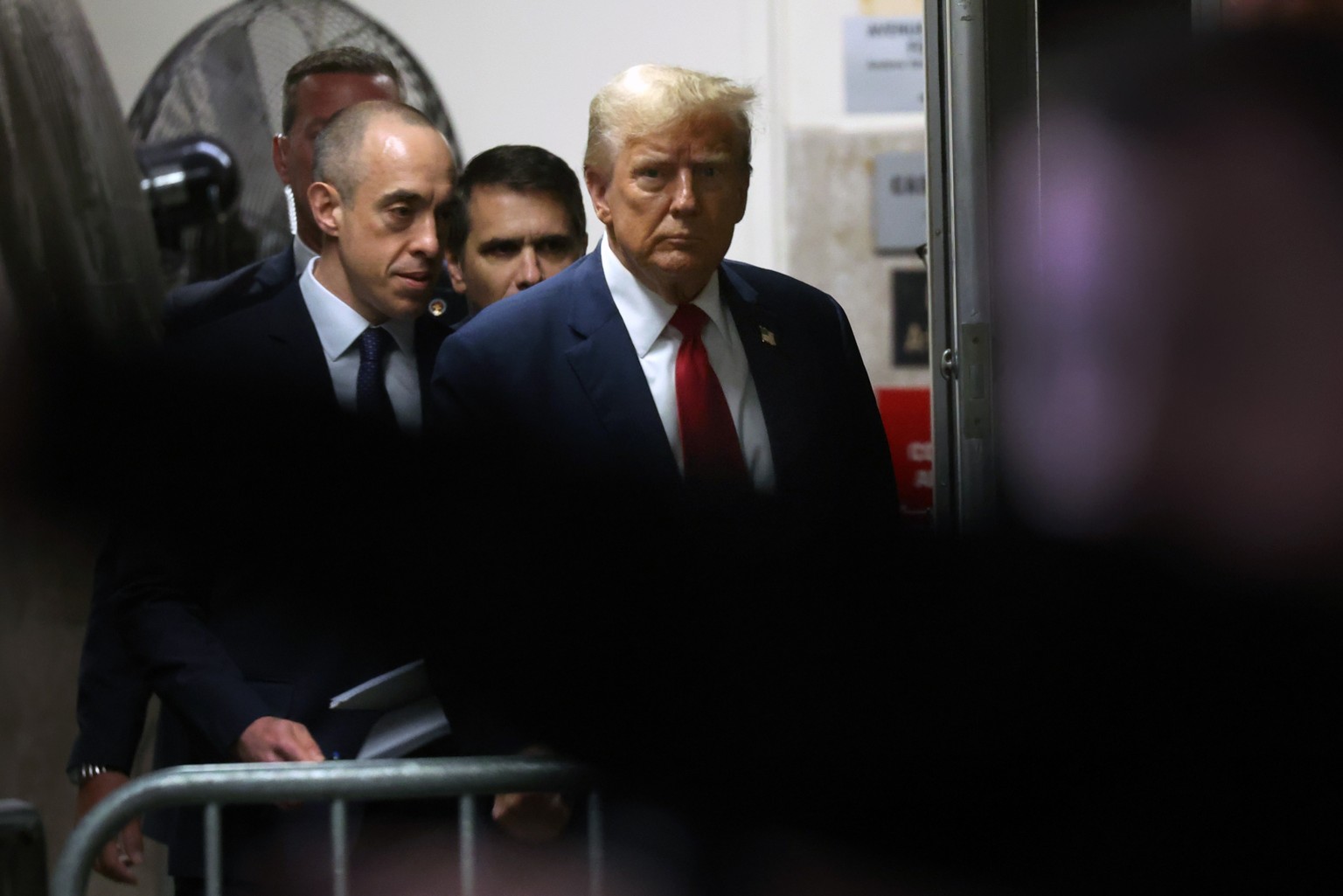 epa11300536 Former US President Donald Trump re-enters Manhattan Criminal Court for the continuation of his hush money trial, in New York, USA, 25 April 2024. Trump is facing 34 felony counts of falsi ...