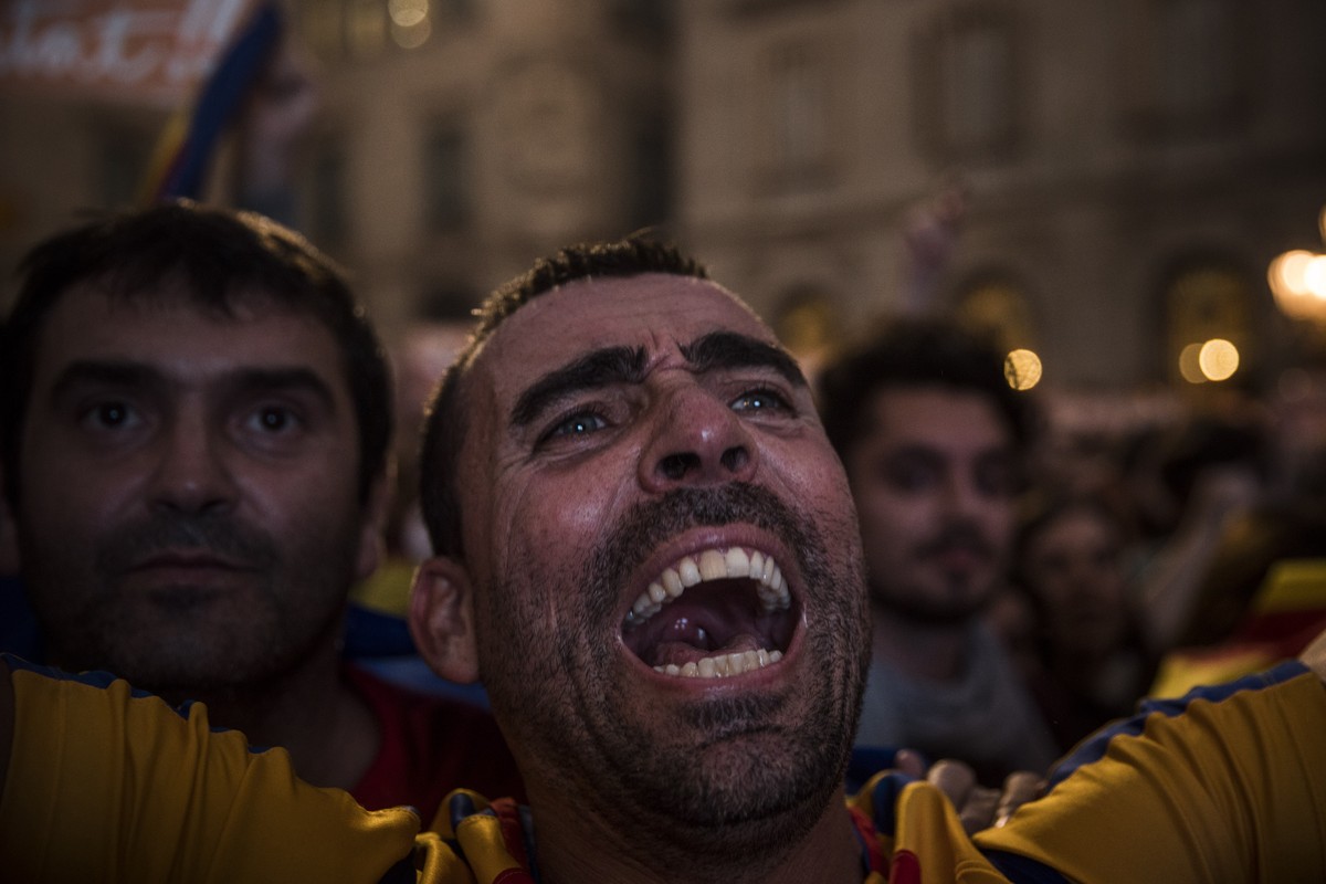 Pro-independence supporters cheer in the square outside the Palau Generalitat in Barcelona, Spain, after Catalonia's regional parliament passed a motion with which they say they are establishing  ...