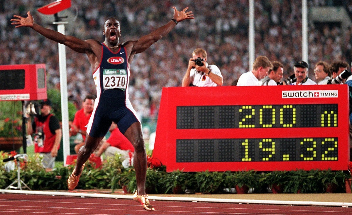 ADVANCE FOR SATURDAY, OCT. 1 - In this Aug. 1, 1996, file photo, Michael Johnson, of the United States, celebrates after he won the men's 200 meter final in a world record time of 19.32 at the 19 ...