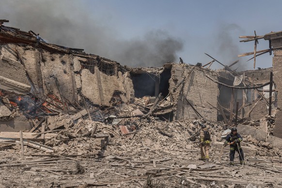 Russian aerial bombardment of the city of Kostiantynivka KOSTIANTYNIVKA, UKRAINE - JULY 11: Ukrainian emergency service workers extinguish a fire in a school, following Russian aerial bombardment of t ...
