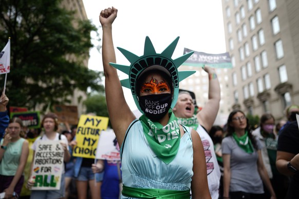 epa10062268 Pro-abortion protesters take part in a Women&#039;s March, in Washington, DC, USA, 09 July 2022. The group are campaigning against the Supreme Courts ruling overturning the 1973 case of Ro ...