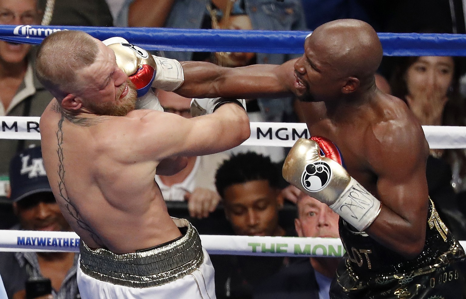 Floyd Mayweather Jr. hits Conor McGregor in a super welterweight boxing match Saturday, Aug. 26, 2017, in Las Vegas. (AP Photo/Eric Jamison)