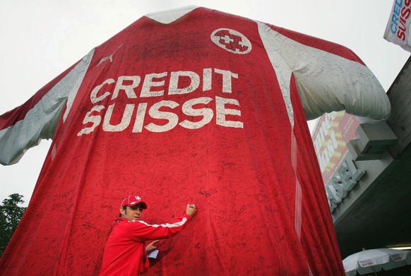 Ein Fan unterschreibt am Mittwoch, 2. Juni 2004 in Basel vor dem Stadion St. Jakob Park kurz vor dem Fussball Freundschaftsspiel der Schweiz gegen Deutschland das Giant Shirt, eine ueberdimensionale N ...