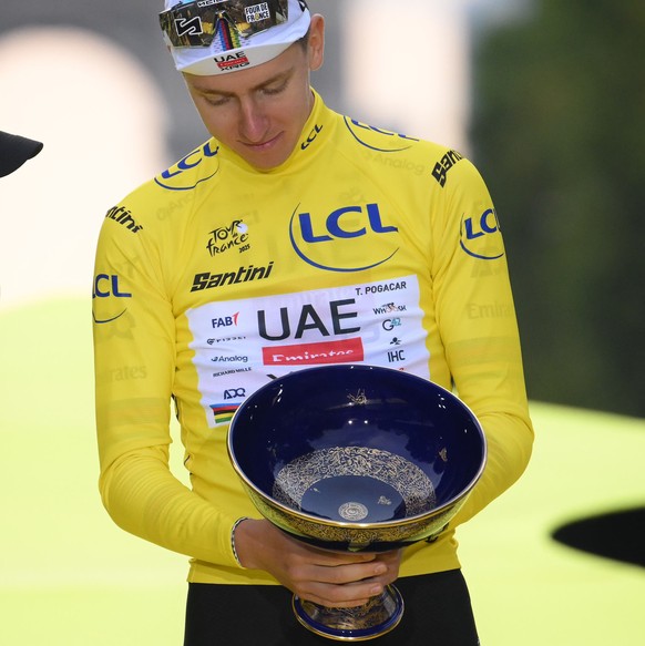 epa12266660 Yellow Jersey overall winner Slovenian rider Tadej Pogacar (C) of UAE Team Emirates, second placed in the overall standings Danish rider Jonas Vingegaard (L) of Team Visma-Lease a Bike and ...