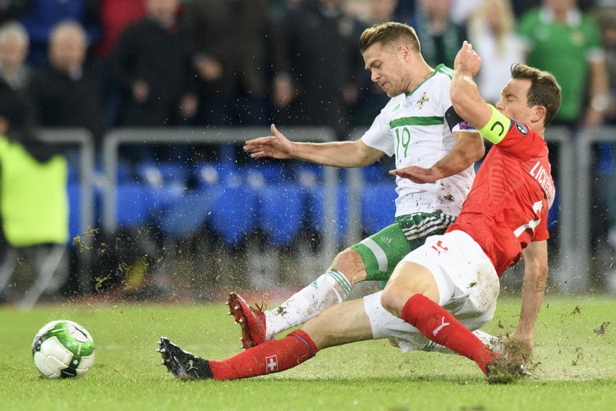 epa06325223 Northern Ireland&#039;s midfielder Jamie Ward (L) fights for the ball against Switzerland&#039;s defender Stephan Lichtsteiner during the 2018 Fifa World Cup play-offs second leg soccer ma ...