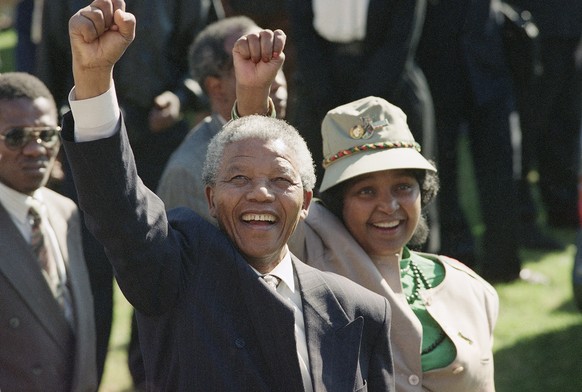 FILE - In this July 7, 1991, file photo, taken by South Africa photographer John Parkin, newly-elected African National Congress President Nelson Mandela and his wife, Winnie, greet supporters at an A ...