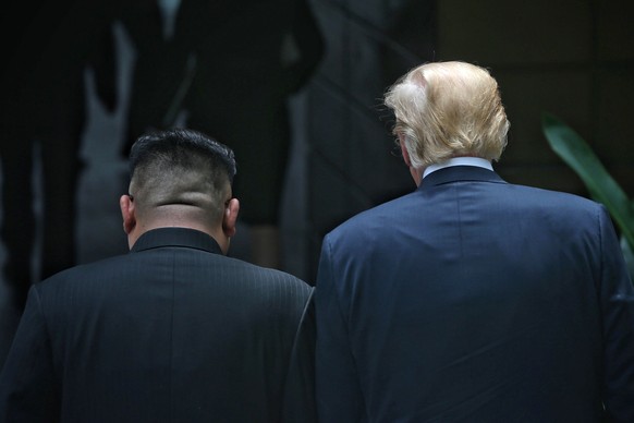 U.S. President Donald Trump, right, and North Korean leader Kim Jong Un walk together during their meeting at the Capella resort on Sentosa Island Tuesday, June 12, 2018, in Singapore. (Kevin Lim/The  ...