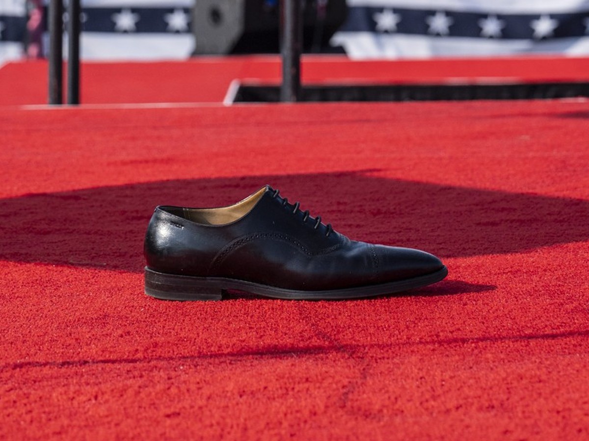 Butler, PA - July 13 : The shoe of Republican presidential candidate former president Donald Trump is seen left on stage after U.S. Secret Service agents removed him from the stage during a campaign r ...
