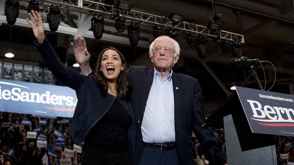 Democratic presidential candidate Sen. Bernie Sanders, I-Vt., accompanied by his wife Jane Sanders, left, and Rep. Alexandria Ocasio-Cortez, D-N.Y., second from right, takes the stage at campaign stop ...
