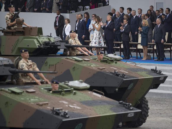 Tanks parade past President Donald Trump, first lady Melania Trump, French President Emmanuel Macron and his wife Brigitte Macron, during Bastille Day parade on the Champs Elysees avenue in Paris, Fri ...