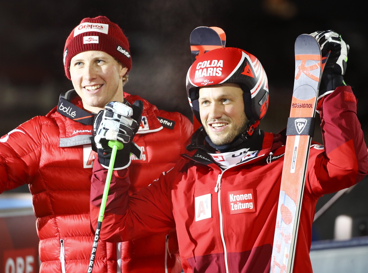Austria's Christian Hirschbuehl, right, winner of an alpine ski, men's World Cup parallel event, celebrates with second-placed Austria's Dominik Raschner, in Lech/Zuers, Austria, Sunday ...