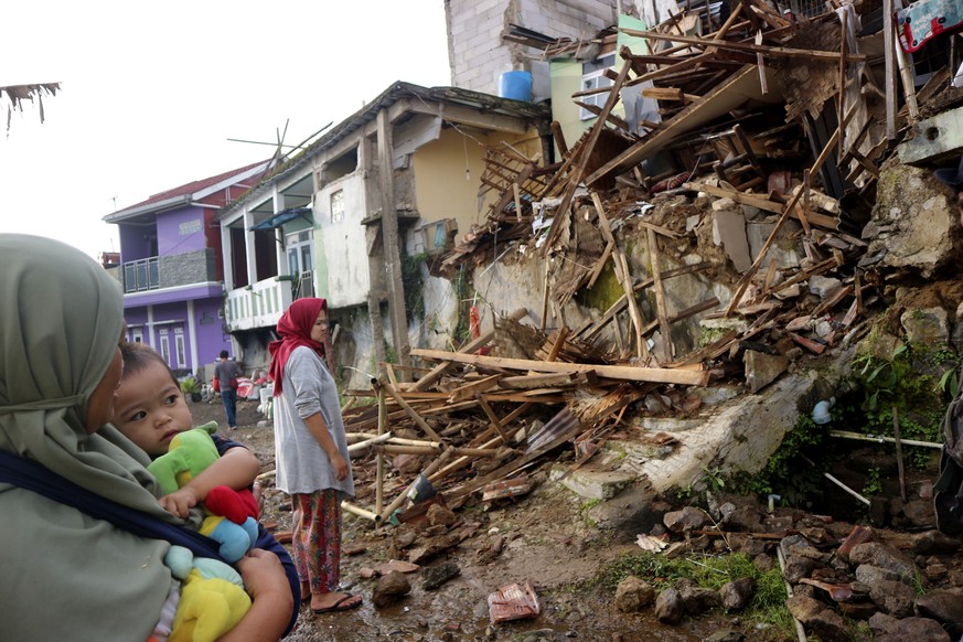 Residents inspect houses damaged by Monday's earthquake in Cianjur, West Java, Indonesia Tuesday, Nov. 22, 2022. The earthquake has toppled buildings on Indonesia's densely populated main island, kill ...