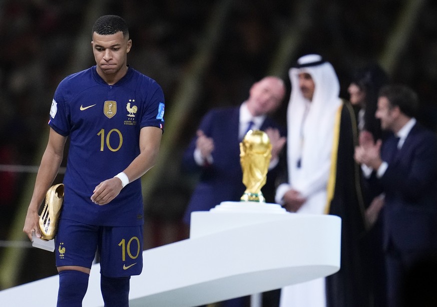 France&#039;s Kylian Mbappe walks with the Golden Boot award for top goal scorer of the tournament during the awards ceremony after Argentina defeated France in the World Cup final soccer match at the ...