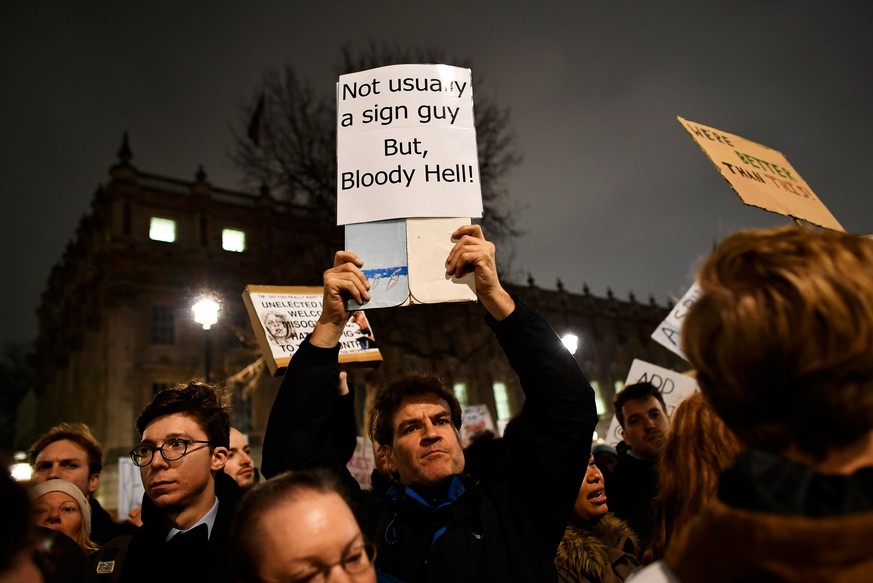 A demonstrator holds a placard during a protest against U.S. President Donald Trump&#039;s executive order travel ban, in London, Britain January 30, 2017. REUTERS/Dylan Martinez