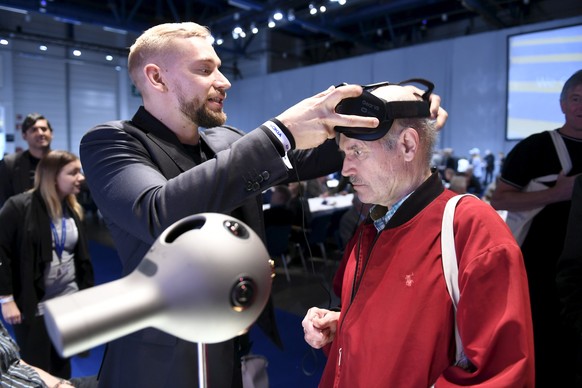 Nokia&#039;s Mikko Korhonen, left, demonstrates to Pauli Kuikka how to use the OZO Virtual Reality camera before a the general meeting of the Finnish telecommunication network company Nokia in Helsink ...