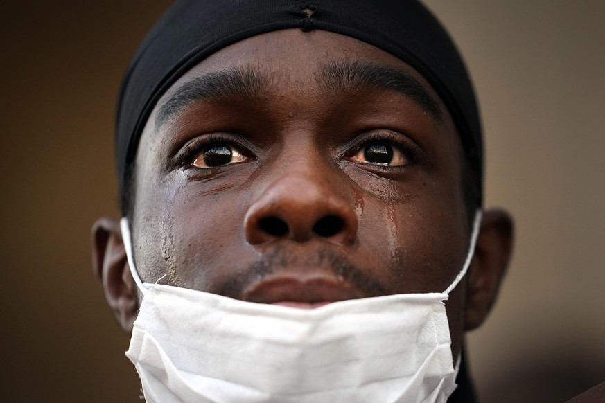 LIVERPOOL, UNITED KINGDOM - JUNE 02: A protester is overcome with emotion as he gathers with thousands of others for a 'Black Lives Matter' solidarity demonstration outside St George's ...