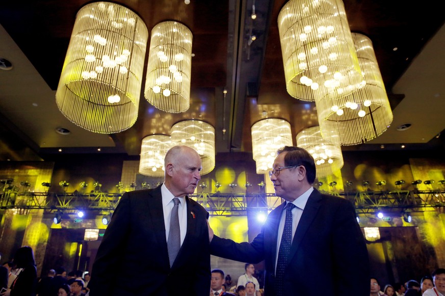 California Gov. Jerry Brown, left, chats with China&#039;s Science and Technology Minister Wan Gang as they attend the Clean Energy Ministerial International Forum on Electric Vehicle Pilot Cities and ...