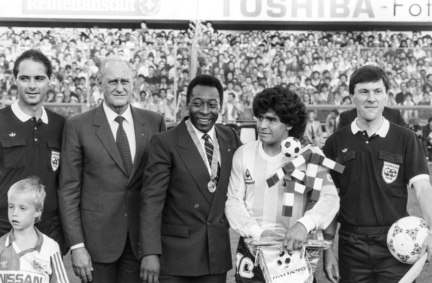 Pele is awarded a medal by the FIFA for his achievements in football at the Hardturm stadium in Zurich, Switzerland, on the occasion of the match between Italy and Argentinia and Diego Maradona, right ...