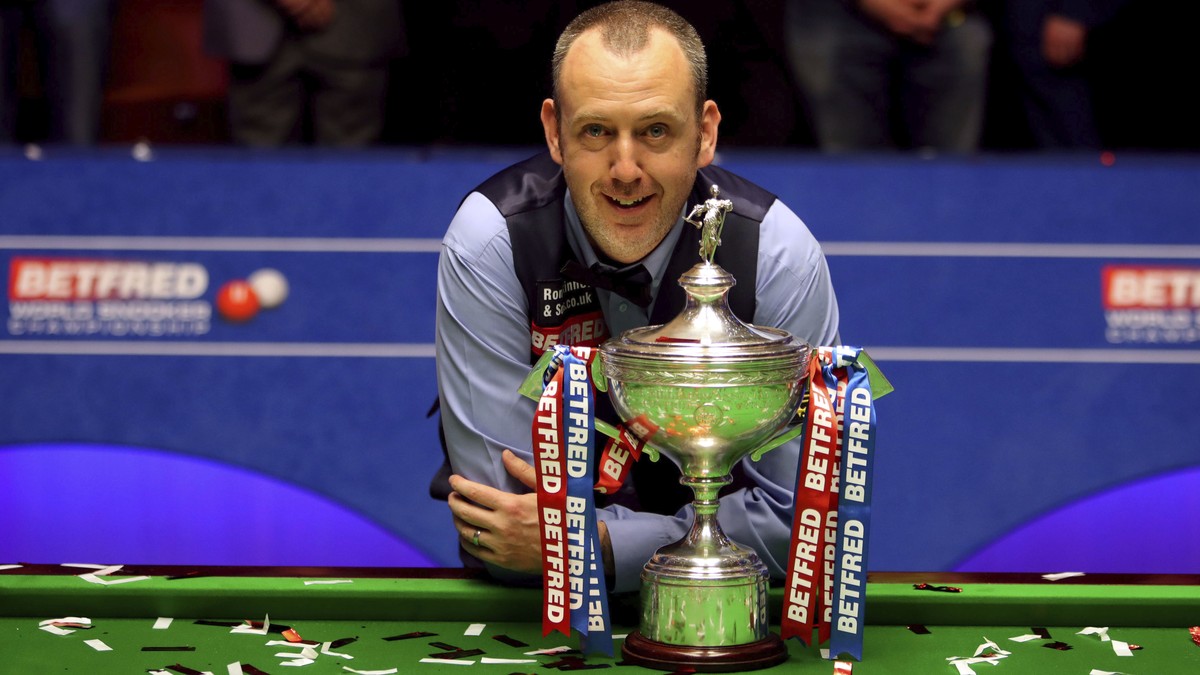 Britain's Mark Williams poses with the trophy after winning the 2018 Snooker World Championship at The Crucible, Sheffield, England, Monday, May 7, 2018. Mark Williams has won the world snooker c ...