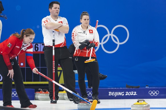 Martin Rios, left, and Jenny Perret of Switzerland team observe during the curling mixed doubles preliminary round game between Czech Republic and Switzerland at the 2022 Olympic Winter Games in Beiji ...