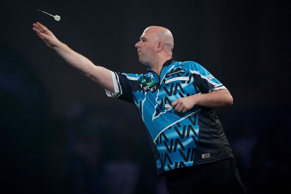 England's Rob Cross competes during his match against England's Ian White on day eleven of the World Darts Championship at the Alexandra Palace, London, Sunday, Dec. 21, 2025. (Bradley Colly ...