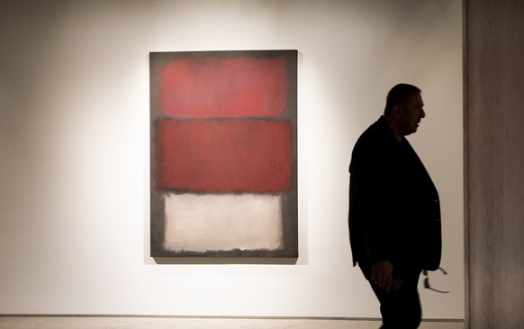 epa07544864 A man walks past the 1960 painting &#039;Untitled&#039; by Mark Rothko, estimated to sell for 35-50 million USD, during a preview of upcoming &#039;Impressionist and Modern Art&#039; and & ...