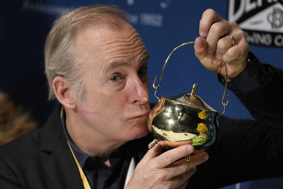 Actor Bob Odenkirk kisses his pudding pot trophy during a a news conference after being honored as Man of the Year by Harvard University&#039;s Hasty Pudding Theatricals, Thursday, Feb. 2, 2023, in Ca ...
