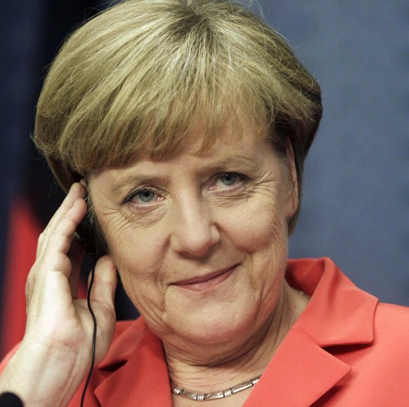 Angela Merkel epa04359131 German Chancellor Angela Merkel listens to a translation on an earphone during a joint news conference with Latvian Prime Minister Laimdota Straujuma (unseen) following their meeting in Riga, Latvia, 18 August 2014. During her visit to the Baltic country Angela Merkel had meetings with the Latvian Prime Minister, with Latvian President Andris Berzins and took part in a discussion on economic cooperation between Germany and Latvia. Merkel and Latvian officials also discussed security issues in the context of the conflict in eastern Ukraine and Russia's import embargo on a broad range of EU food products. EPA/VALDA KALNINA