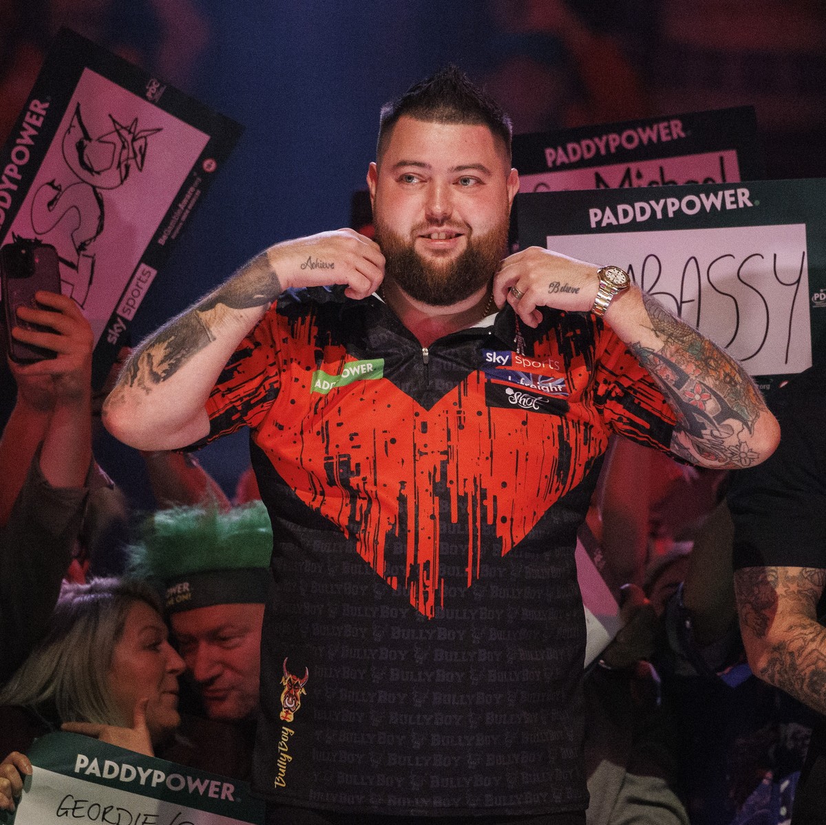 epa11031732 Michael Smith of England arrives to play against Kevin Doets of The Netherlands (not pictured) during the opening session of the Paddy Power World Darts Championship at Alexandra Palace in ...