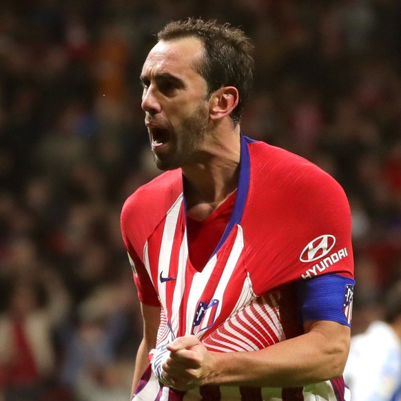 epa07125079 Atletico Madrid&#039;s Diego Godin (R) and teammate Angel Correa (L) celebrate after scoring the 1-0 lead during a Spanish LaLiga soccer match between Atletico Madrid and Real Sociedad at  ...