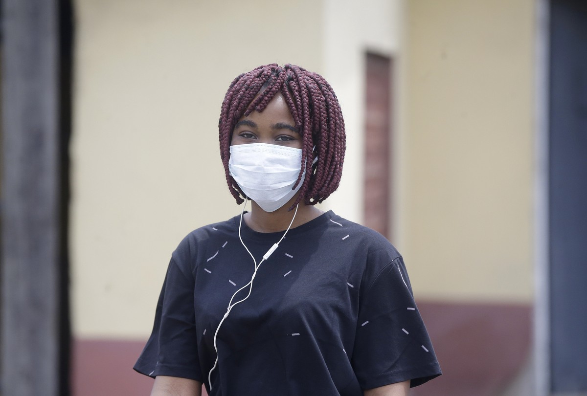 A woman wearing a face mask walks at the Yaba Mainland hospital where the first Nigerian victims of the COVID-19 virus are being treated in Lagos Nigeria Friday, Feb. 28, 2020. Nigeria's health a ...