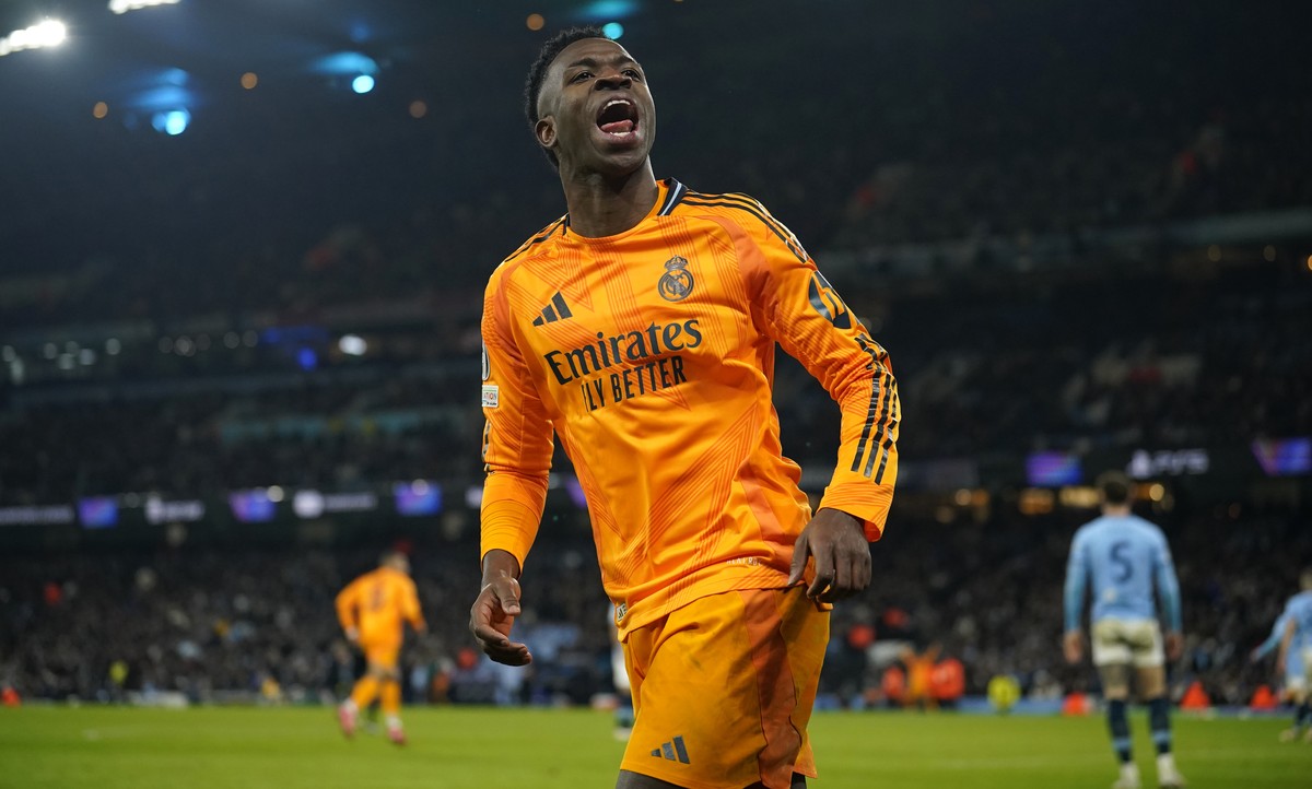 Real Madrid's Vinicius Junior celebrates after his teammate Real Madrid's Brahim Diaz scored their side second goal during the Champions League playoff first leg soccer match between Manches ...