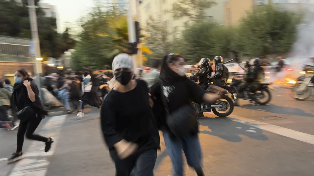 FILE - In this Monday, Sept. 19, 2022, photo taken by an individual not employed by the Associated Press and obtained by the AP outside Iran, women run away from anti-riot police during a protest of t ...