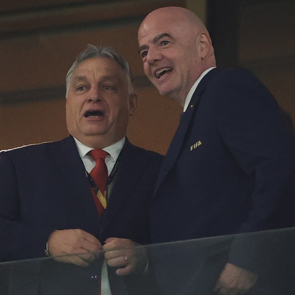 epa10363897 Prime Minister of Hungary Viktor Orban speaks with FIFA President Gianni Infantino (R) ahead of the FIFA World Cup 2022 semi final between Argentina and Croatia at Lusail Stadium in Lusail ...