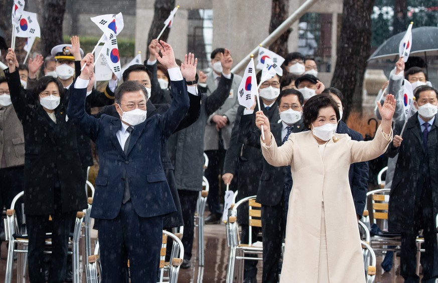 epa09043885 South Korean president Moon Jae-in (2-L) and his wife Kim Jung-Sook (2-R) react during a ceremony to mark Independence Movement Day, in Seoul, South Korea, 01 March 2021. South Korea celeb ...